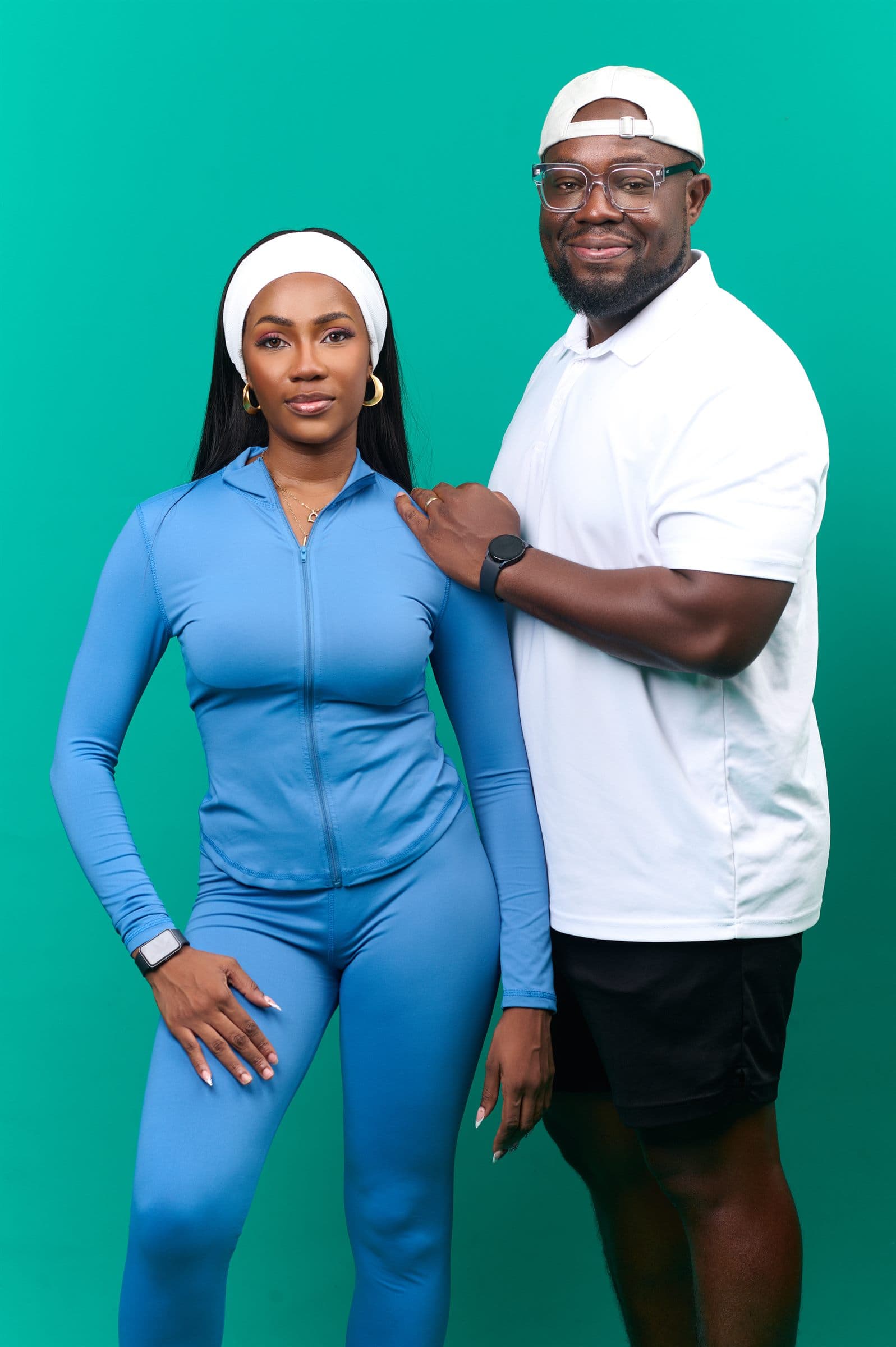 Couple in matching blue against a teal backdrop