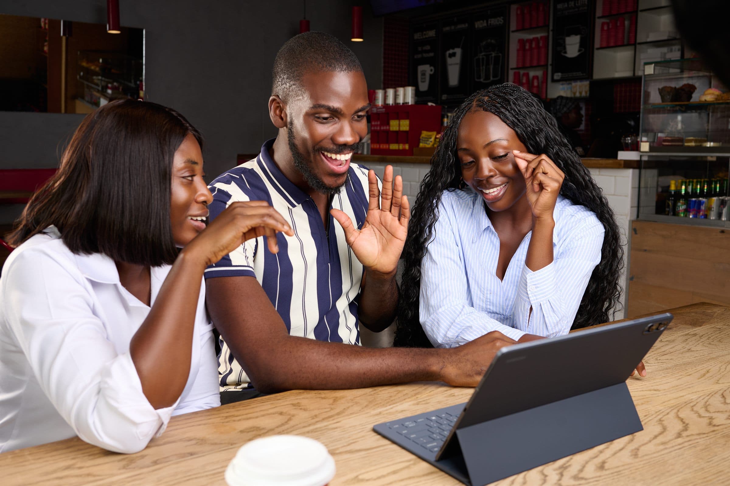 Group of three collaborating over a tablet